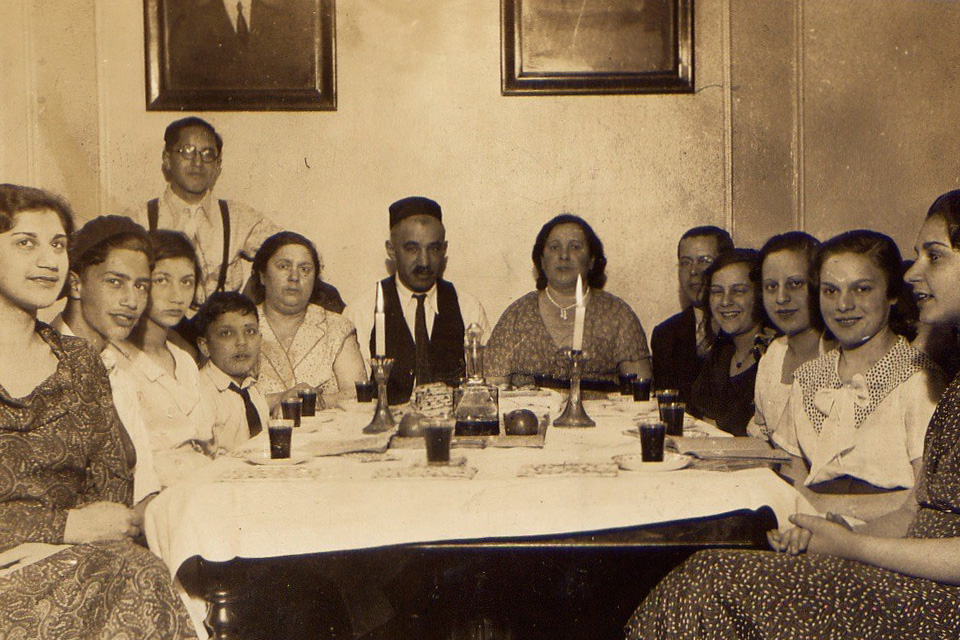 Future Smithsonian Folkways Recordings artist Joe Glazer (second from left) sits with a dozen family members and friends at a 1933 Passover Seder in the Bronx, New York