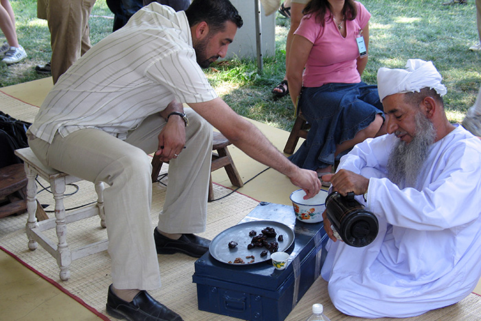 A presentation of Omani hospitality with dates and coffee at the 2005 Folklife Festival. Photo by Rebecca Summerour, Ralph Rinzler Folklife Archives