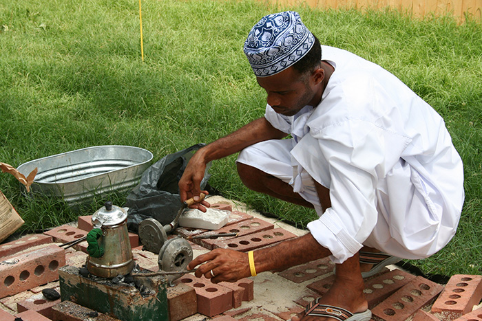 A participant prepares coffee at the 2005 Folklife Festival's Oman program. Photo by Jillian Foley, Ralph Rinzler Folklife Archives
