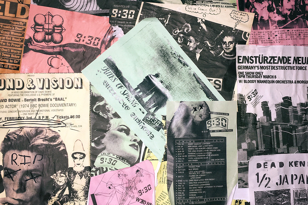 Many layers of black-and-white photocopied flyers on colored paper on a bulletin board