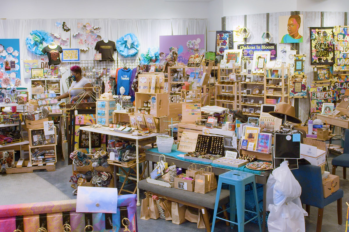 Bright interior of a store chock full of art and craft items on blonde wood shelving.