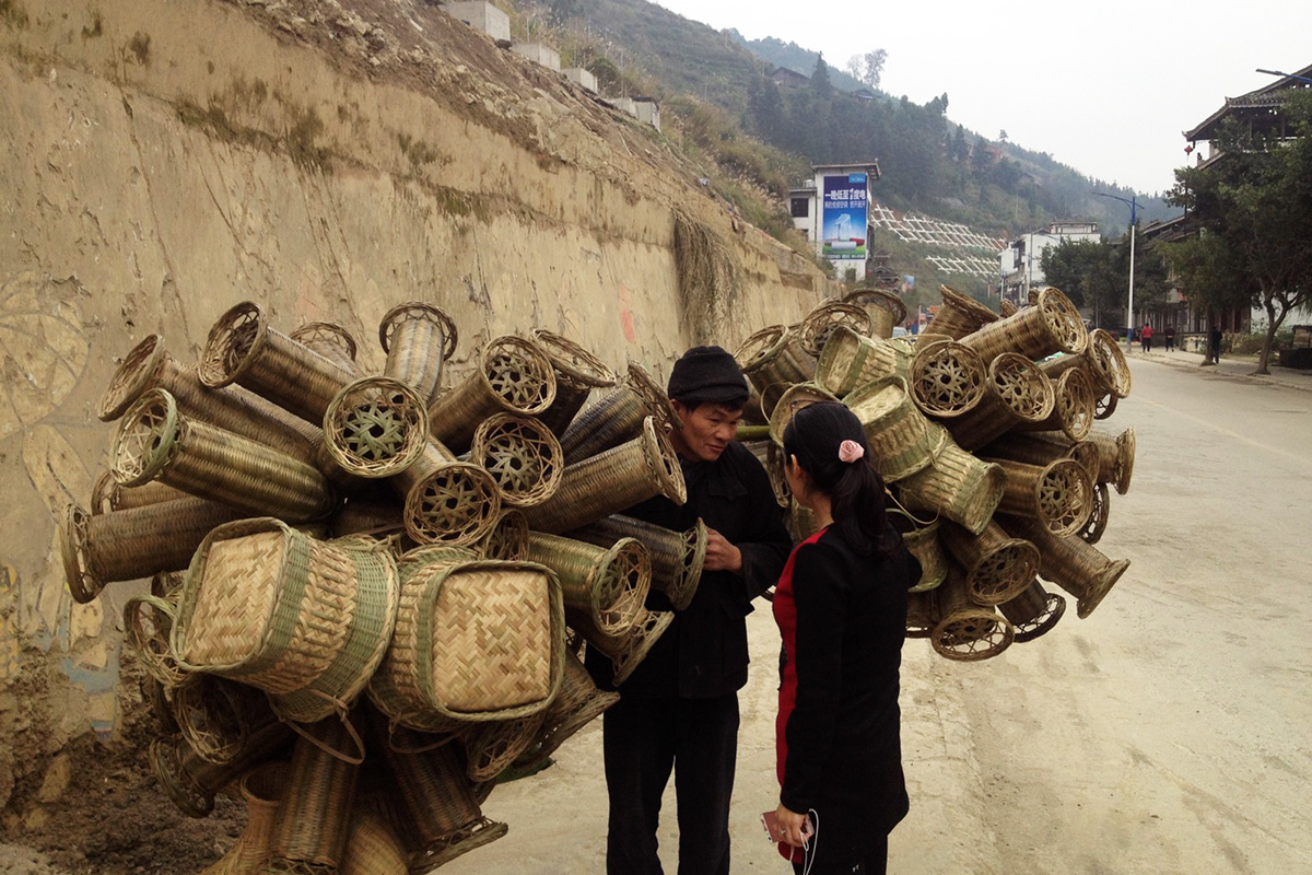 A basket seller carts his wares in Guandong town, a predominantly Dong community in Guizhou Province. 