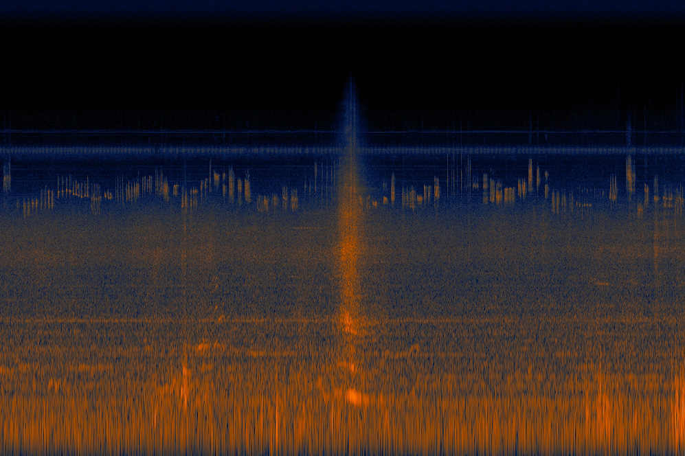 A spectrograph image shows bands of orange and blue across the bottom and middle. The top is mostly black, representing an absence of loud at that volume. In the center is a more definite block of orange, from when a car passed by.