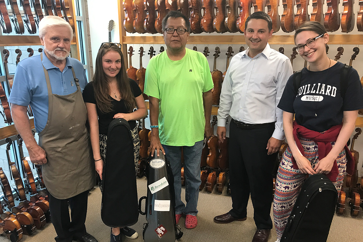Robertson & Sons Violin Shop generously donated violins to The Heartbeat Project in 2017. Left to right: shop owner Dan Robertson, music teacher Leerone Hakami, Navajo Technical University professor Wesley Thomas, Dan’s son Aaron Robertson, and Heartbeat Project director Ariel Horowitz. Photo courtesy of The Heartbeat Project