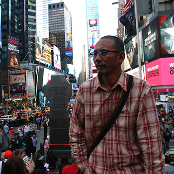A man walks through Times Square.