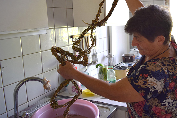 Greta handles tough, long braids of dried aveluk with ease as she prepares her signature salads. Photo by Karine Vann, Smithsonian