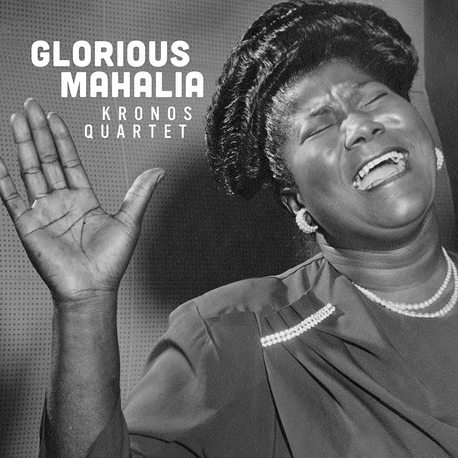 Album cover for Glorious Mahalia by Kronos Quartet features a black-and-white photo of Mahalia Jackson singing with a raised hand, closed eyes, and open mouth. She is wearing a dress, earrings, and pearls.
